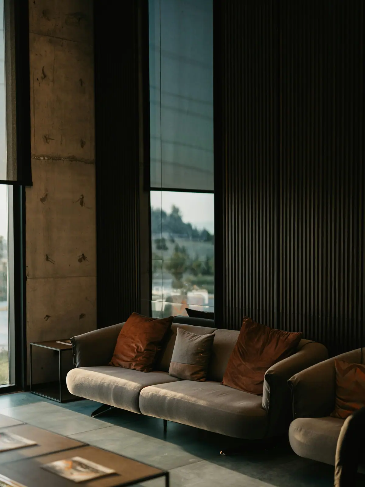 Living room with dark wood slat wall and a leather sofa