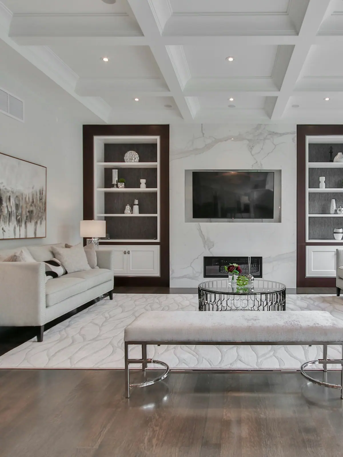 Living room with a marble fireplace and coffered ceiling