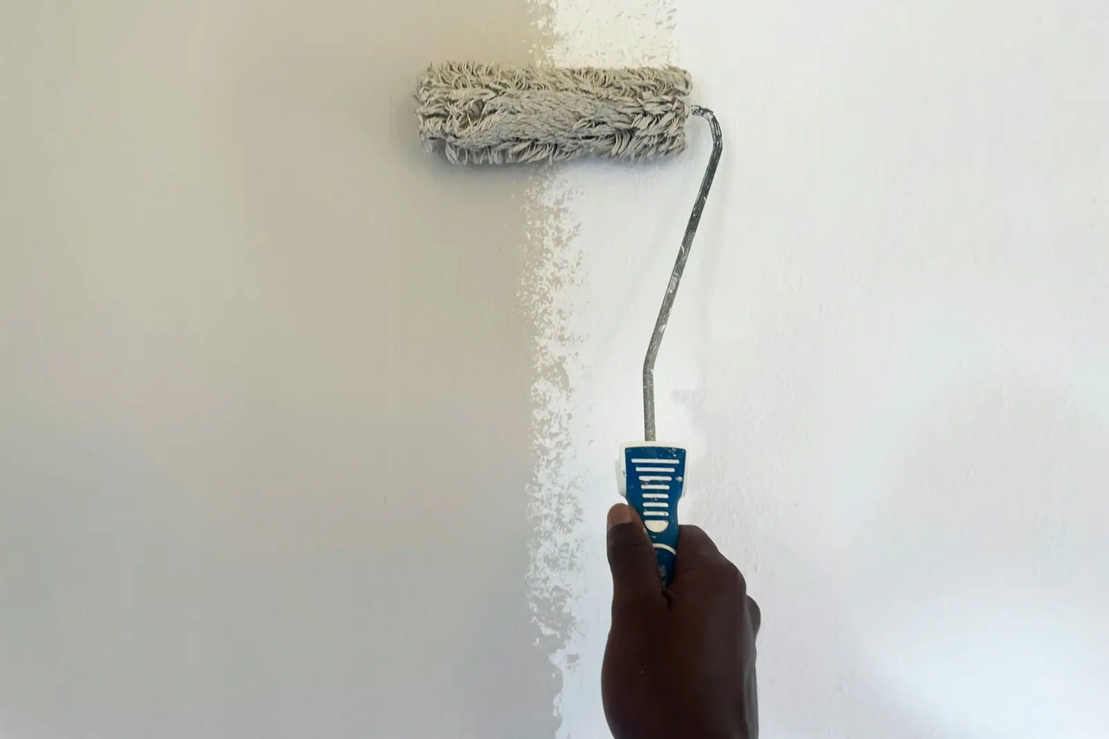 White wall paint being applied with a roller