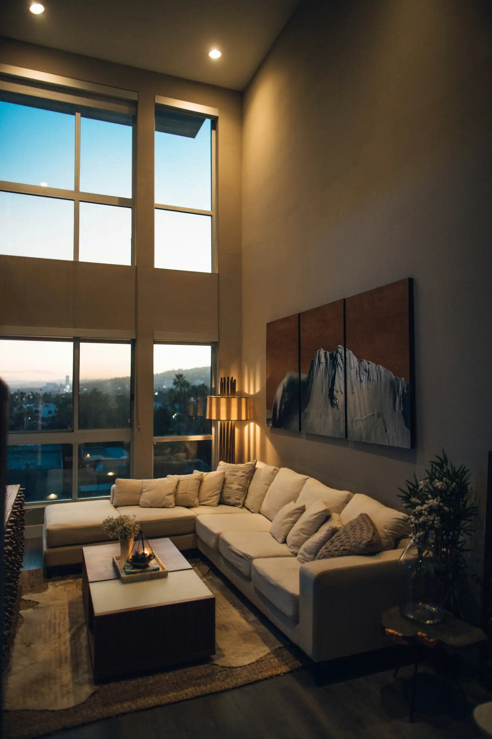 Remodeled living room with high ceilings in evening light