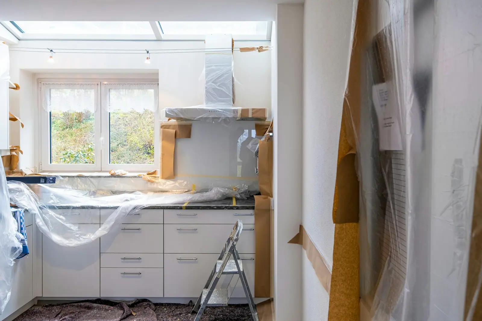 Kitchen covered in plastic sheeting during tear-out