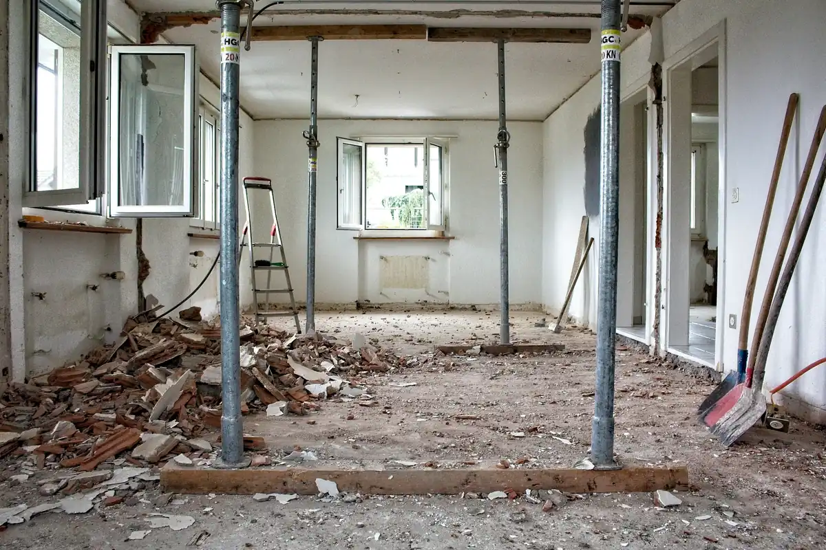 Empty living room during demolition with scaffolding