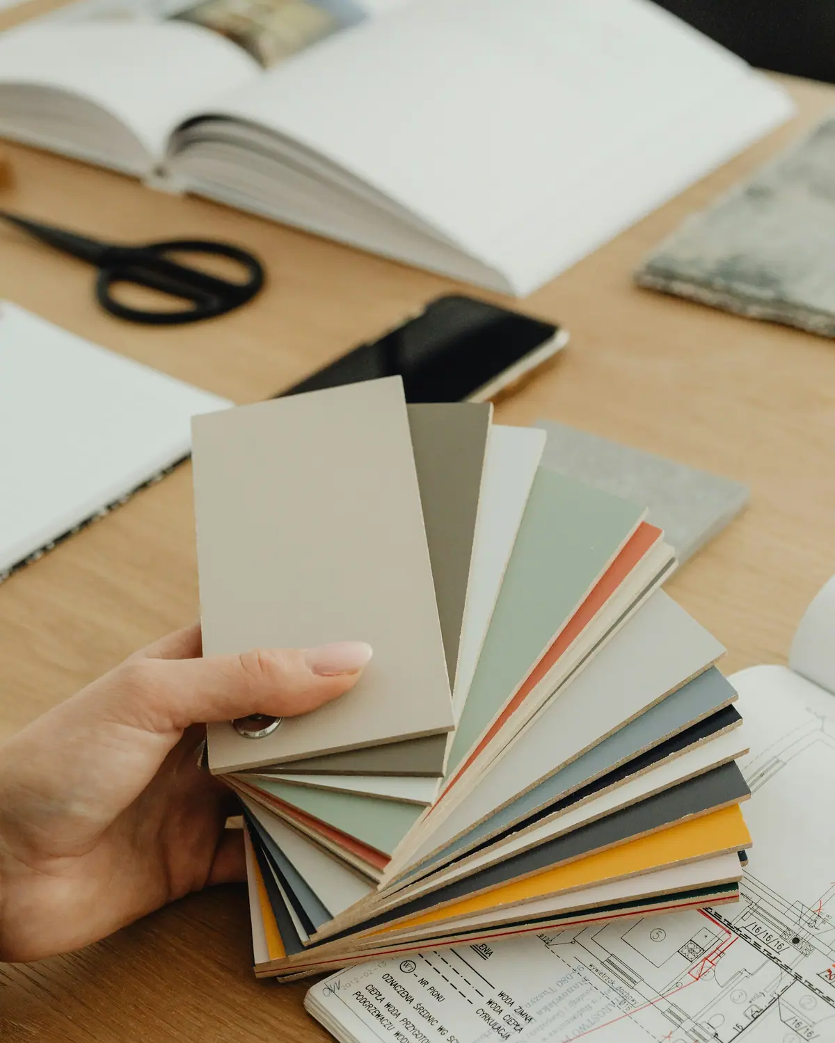 Working over a color fan deck and design drawings